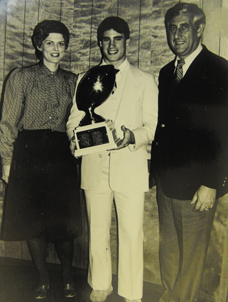 Being awarded High School Football M.V.P with my step-mother and father standing proudly by. The photo was taken by John Buckley, who passed away the same year at only 55 years of age of prostate cancer. His son Mike was also one of the team's MVP's.